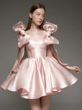 A woman modeling a light pink satin formal dress with dramatic ruffled shoulder details and a flared skirt, shown against a dark gray studio background. The brand name 'Lusilk' appears at the top with Chinese characters, and 'Customized formal dress' is printed at the bottom.